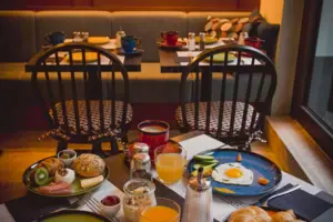 A table with plates of food and drinks.
