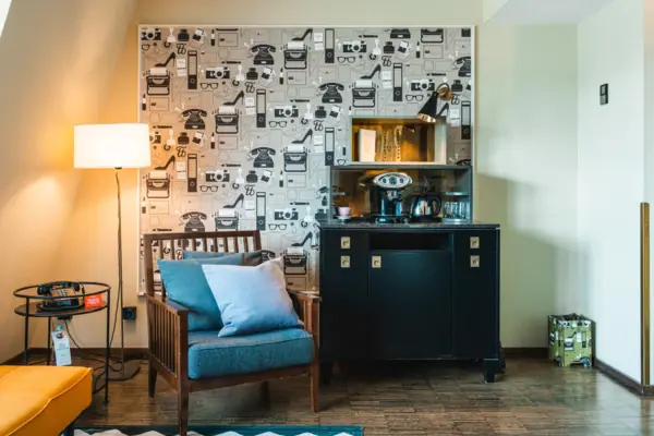 Armchair and cupboard with coffee and tea station