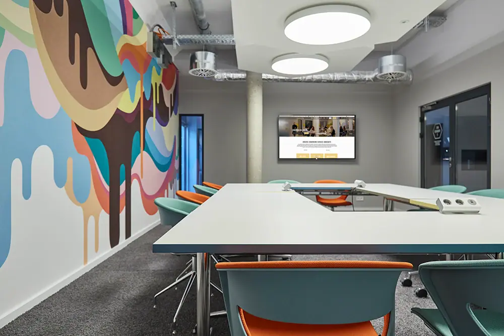 A room with a large table and chairs.