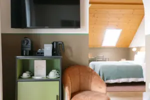 A room with a television and a chair.