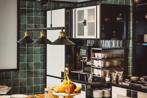 A kitchen with a variety of dishes on the worktop.