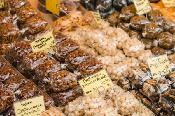 A selection of bags of nuts at a market.