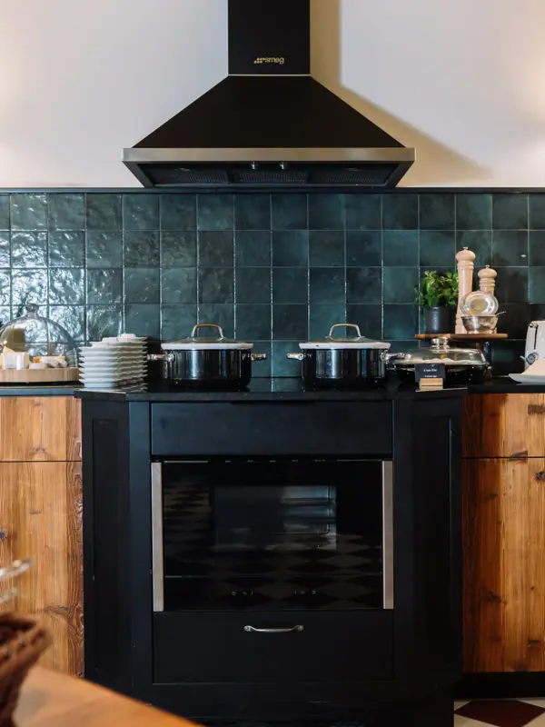 A kitchen with black appliances and a black stove.