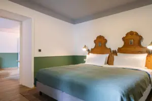 A bed with two wooden headboards in a room.