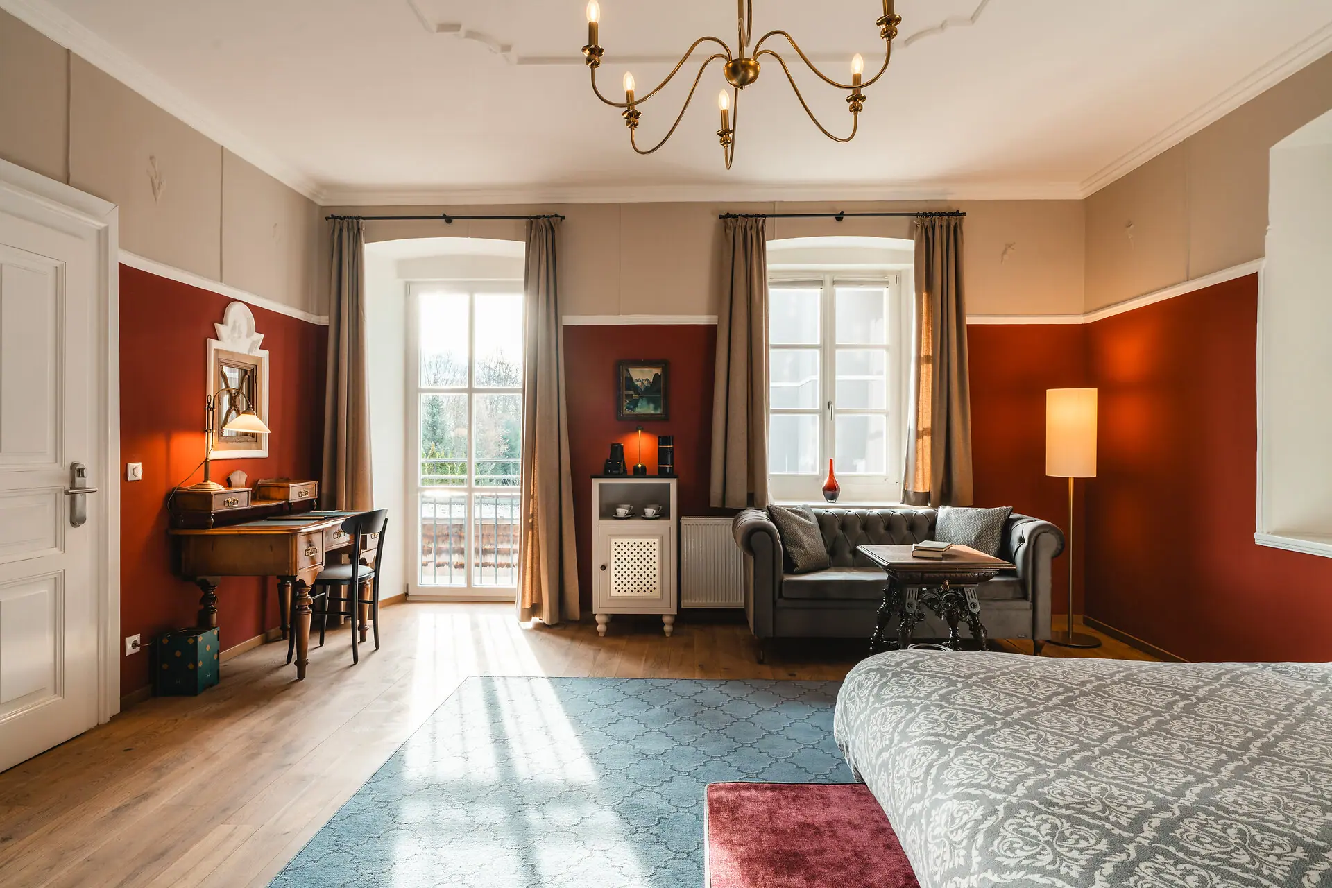 A room with a sofa and a desk.