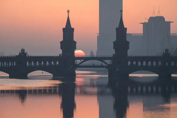 Bridge over water with sunset in the background