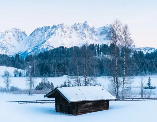 A snow-covered hut in the open air.