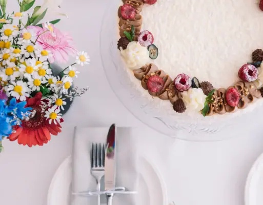 Hochzeit im HENRI Hotel Kitzbühel mit einem Kuchen und Blumen.