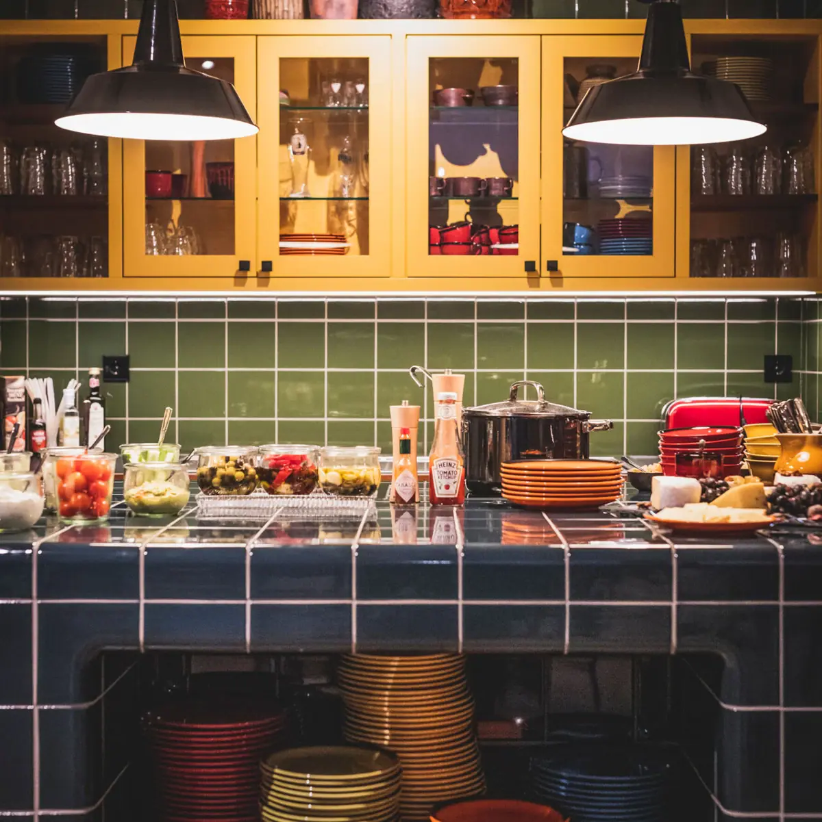 Kitchen with worktop and green tiled wall