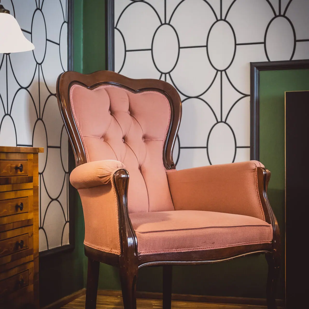 A pink armchair in a room.