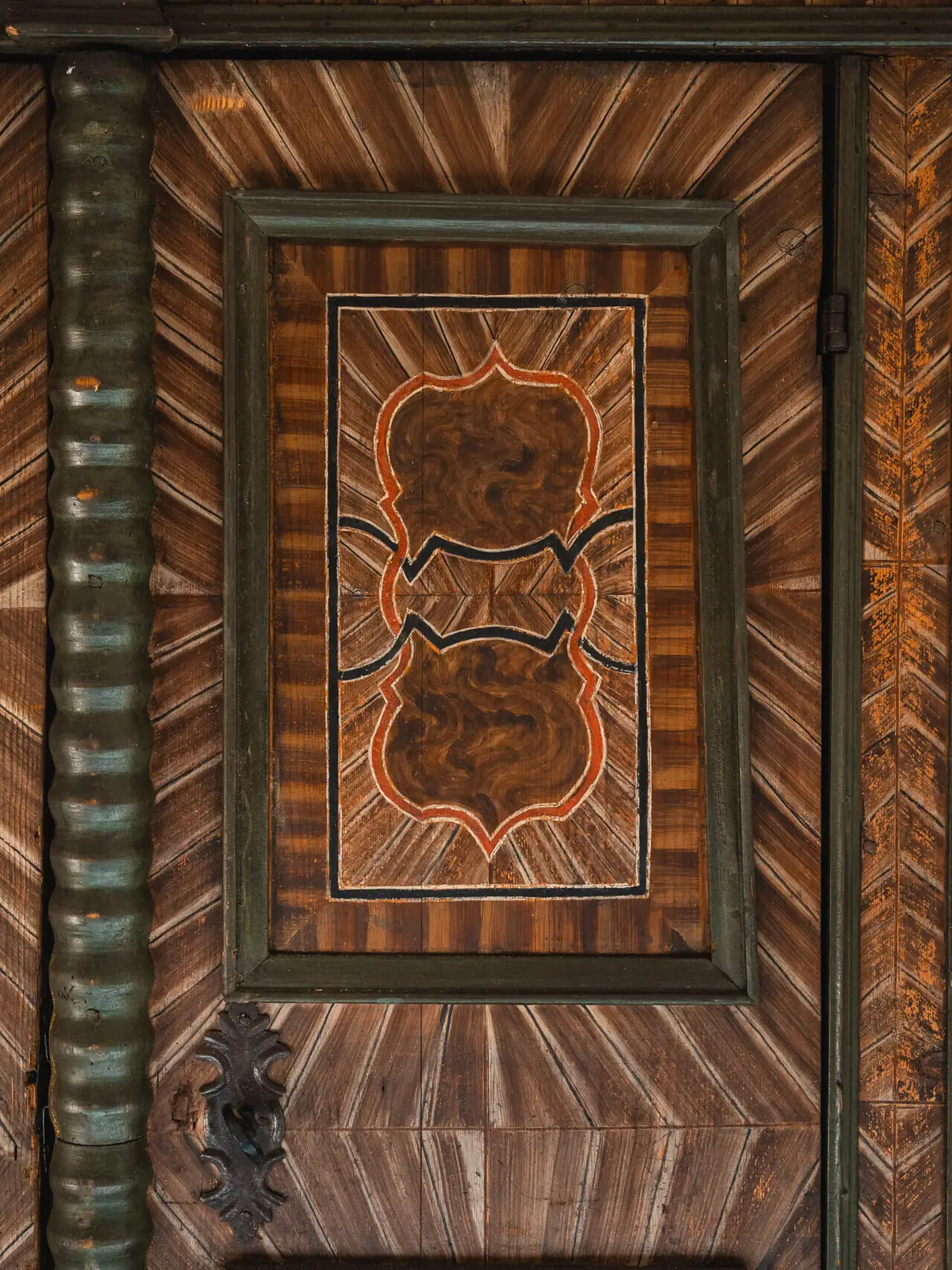 Wooden door with artistic design and symmetrical patterns.