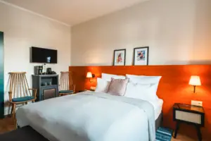 Bed with white ceiling and red headboard