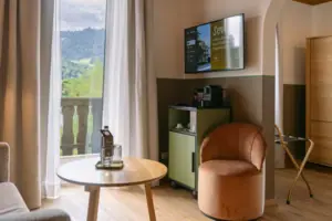 A room with a television and a chair.