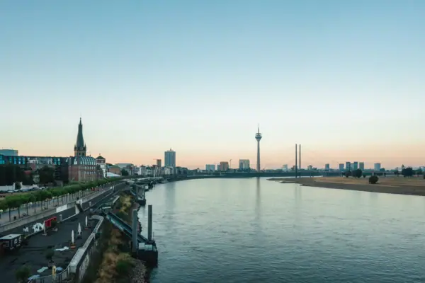 River with a bridge and city skyline in the background.