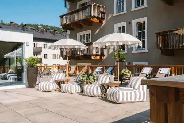 HENRI Spa A patio with chairs and parasols.