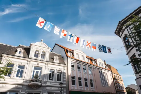 A row of buildings with flags.