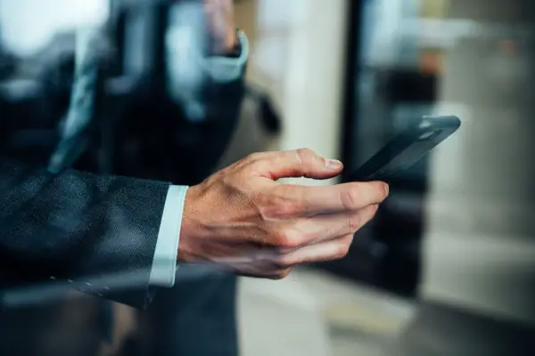 A hand is holding a mobile phone.