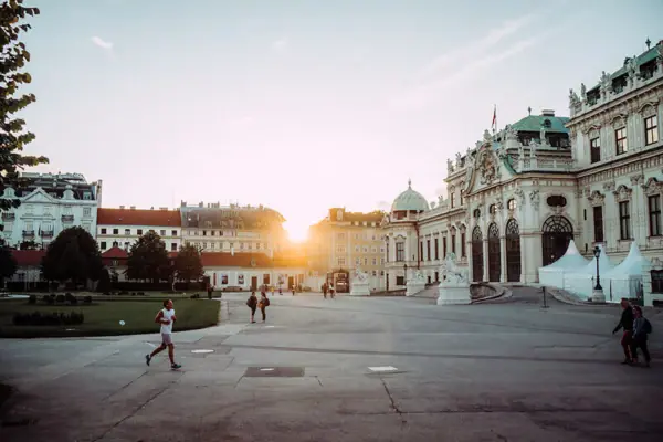 A person is walking in a courtyard.