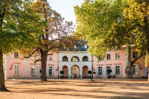 A building with trees in the foreground.