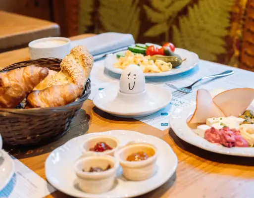 A table with plates of food and an egg.