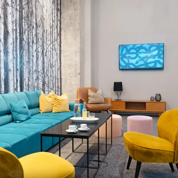 A room with a couch and a coffee table.