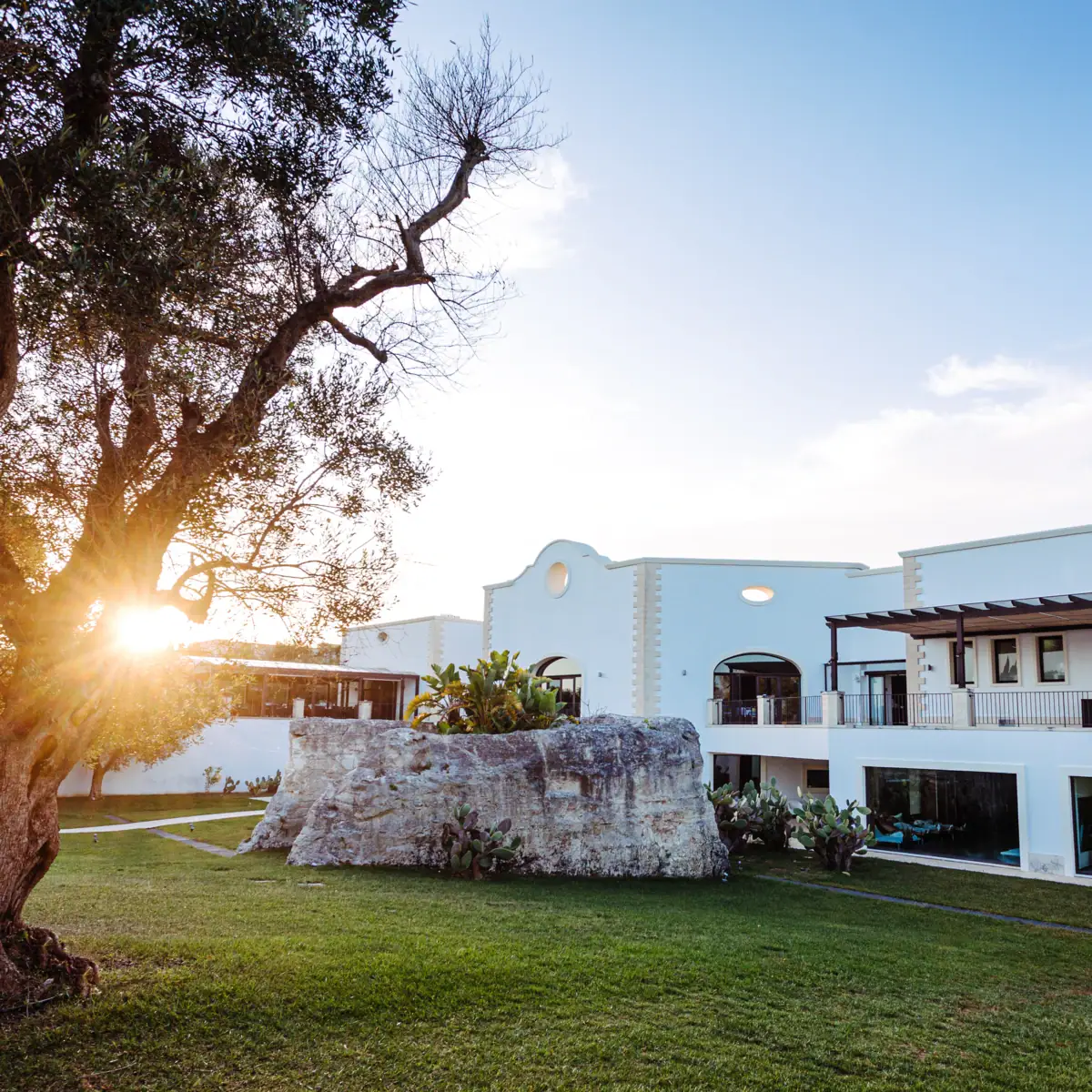 A building with a large rock in front of it.