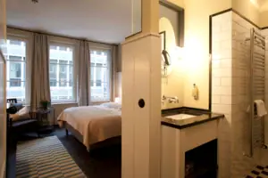 Hotel room with bed and washbasin