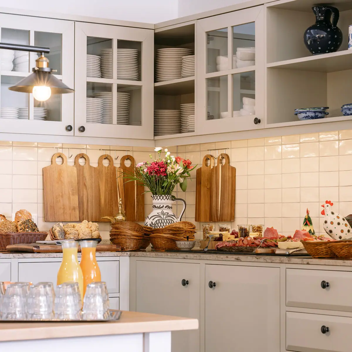 A kitchen with white cupboards and white worktops.