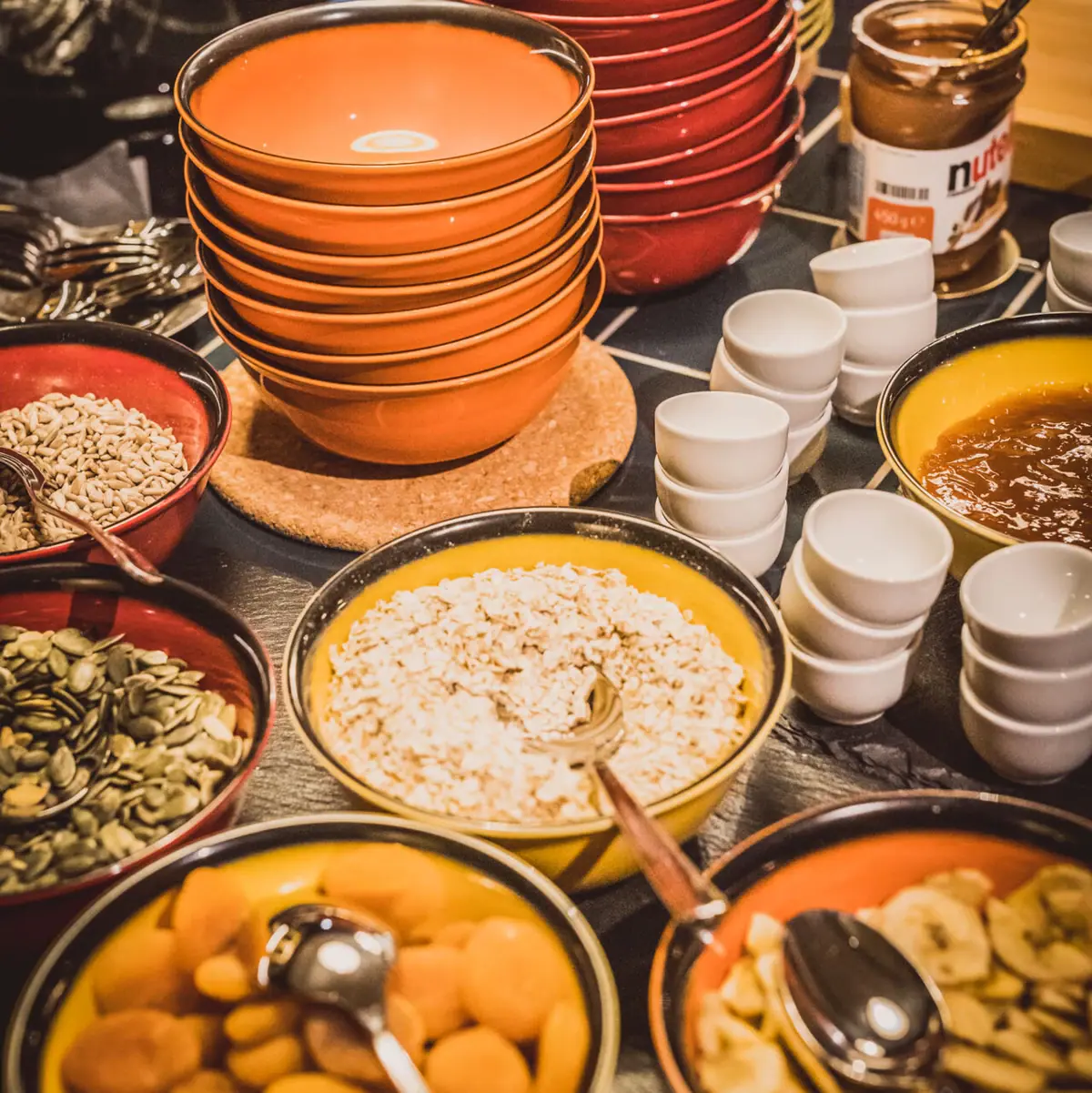 A table with bowls full of different dishes.