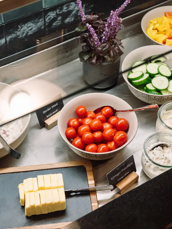 Counter with bowls of assorted food and vegetables indoors.