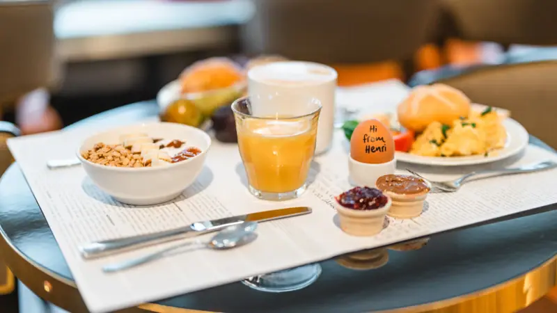 Breakfast served at a table with a variety of food and drinks.