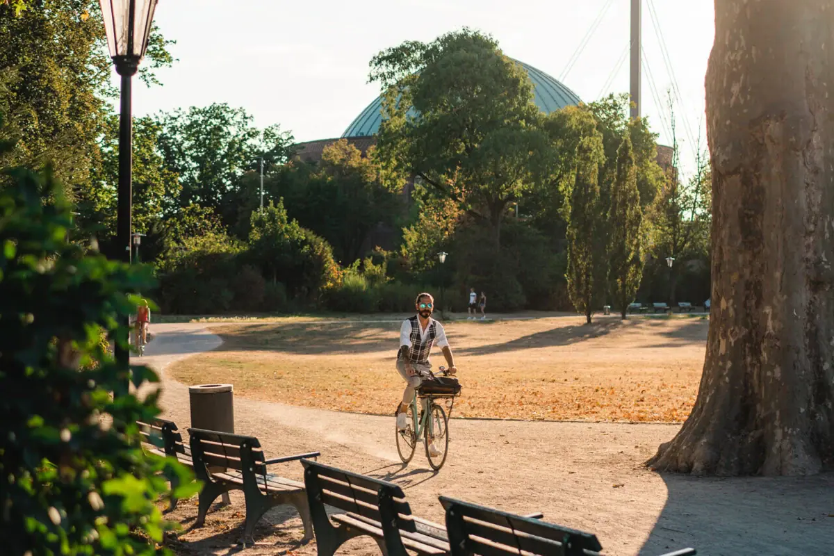 A person is cycling in a park.