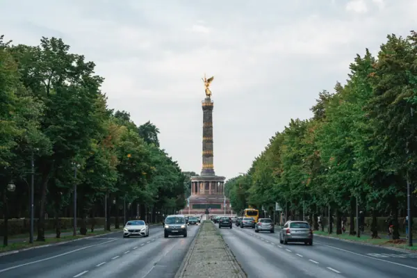 Street with cars and a statue on top