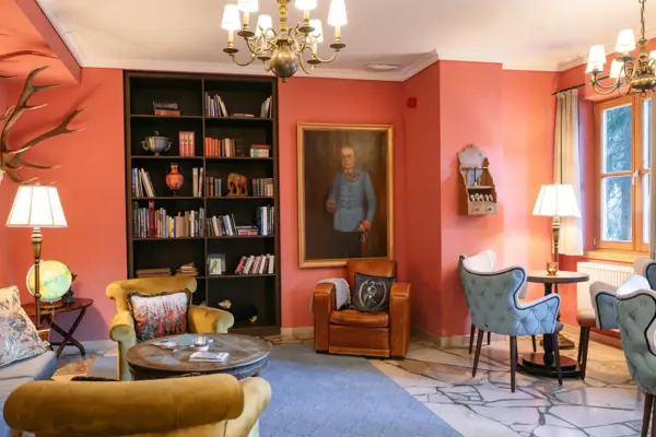 Living room with a painting of a man on the wall.