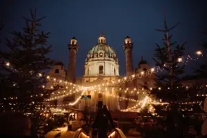 An illuminated building with a dome at night.