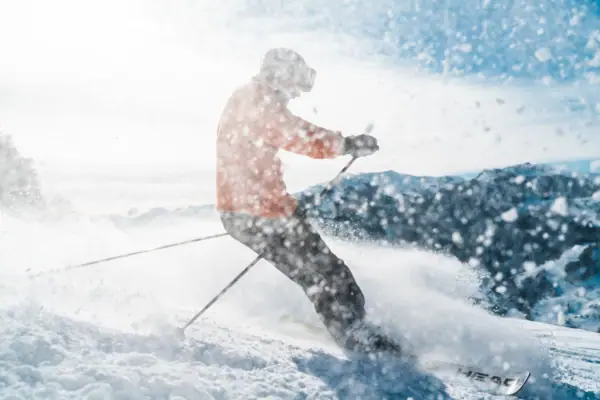 A person is skiing down a snow-covered slope.