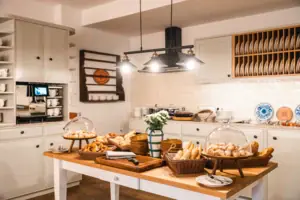 The HENRI in-house kitchen at Hotel Kitzbühel with a table with food on it.