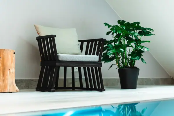 A chair next to a swimming pool.