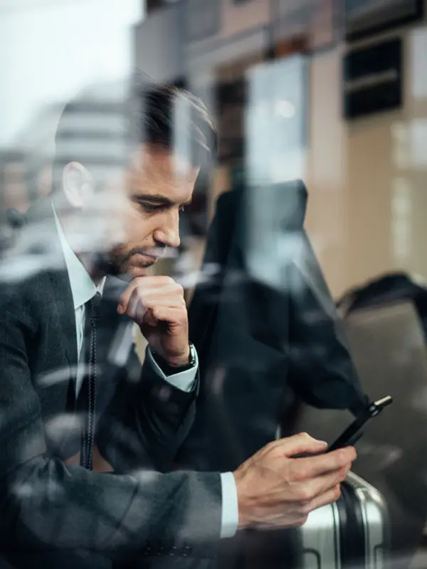 A man is looking at his mobile phone.