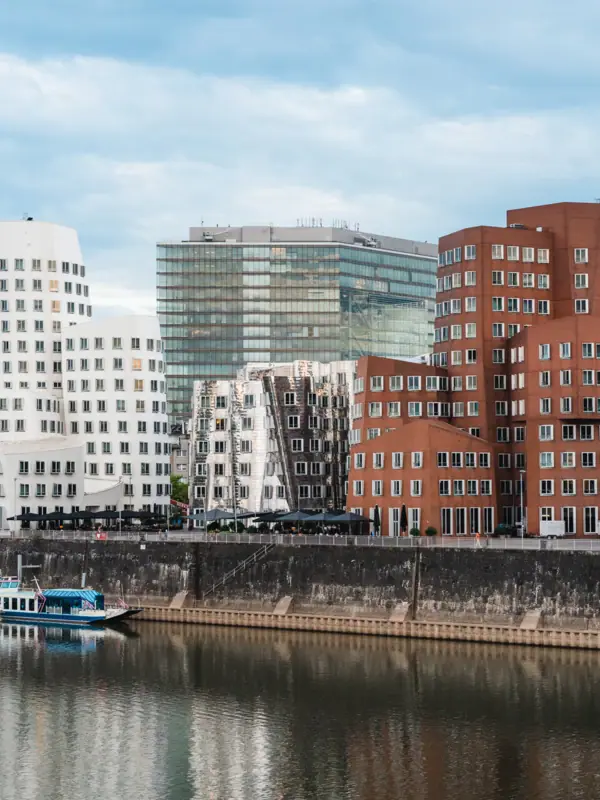 A river with boats and buildings in the background.