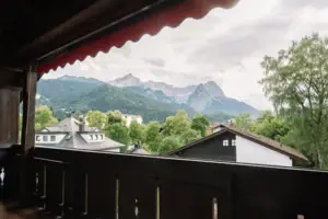 A view of mountains and trees from a balcony