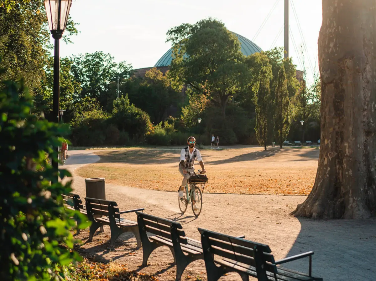 A person is cycling in a park.