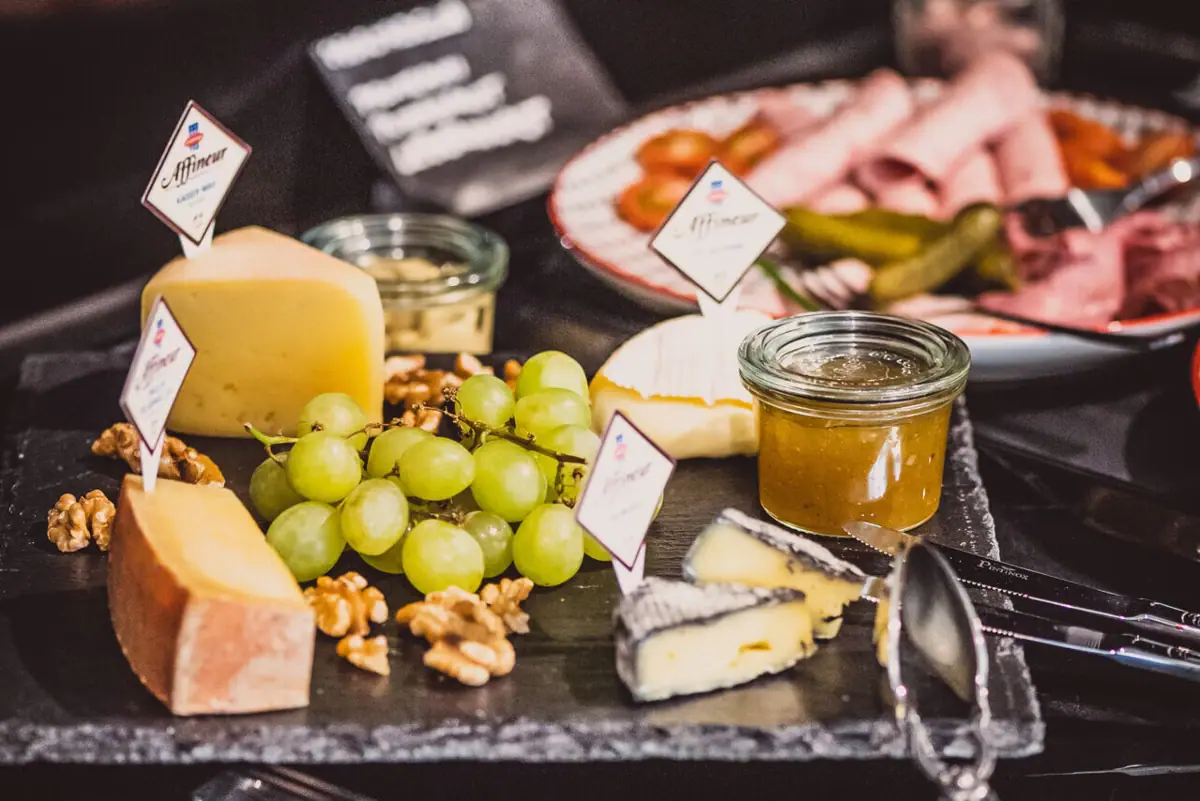 A plate with a meal and grapes on a table.