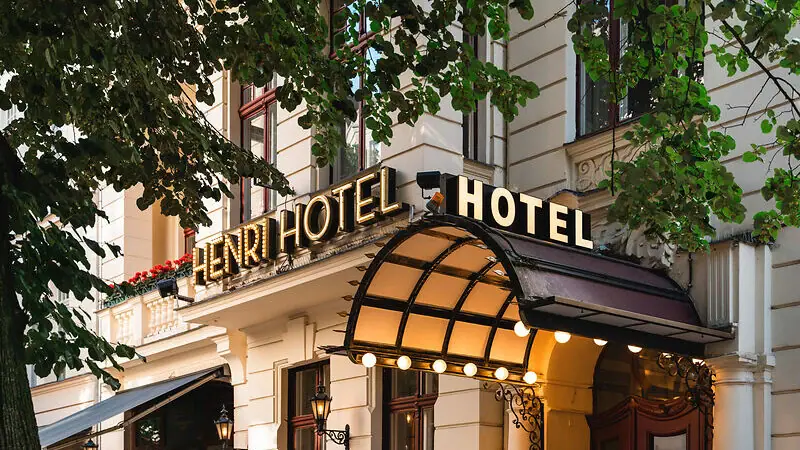 Hotel building with illuminated façade and windows.