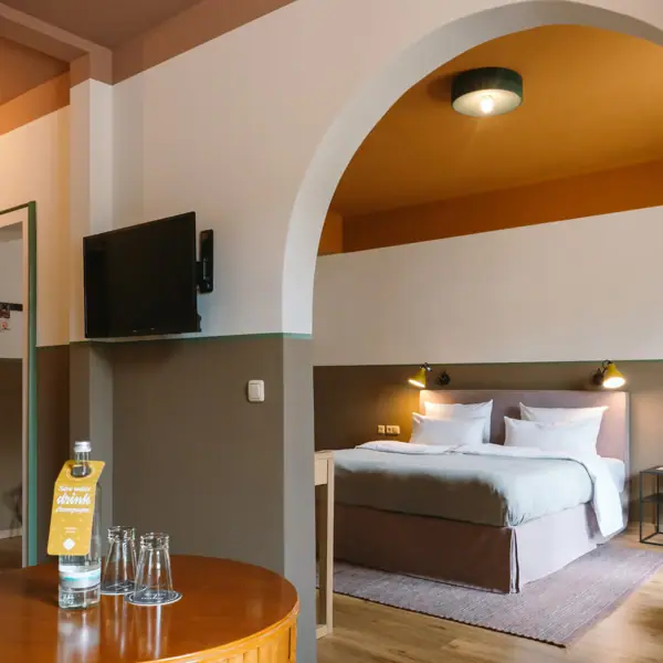 A well-furnished room featuring a bed and a television.