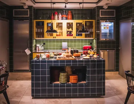 A kitchen with counter and chairs.