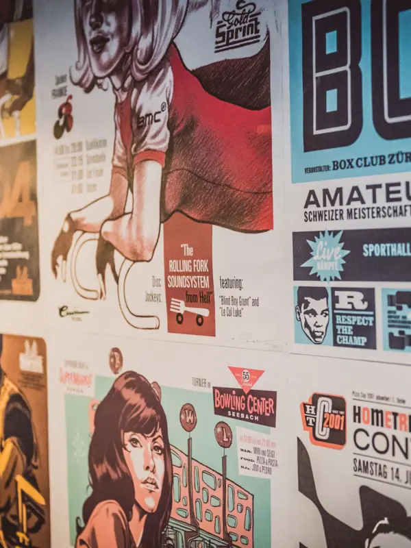 A wall with several posters.