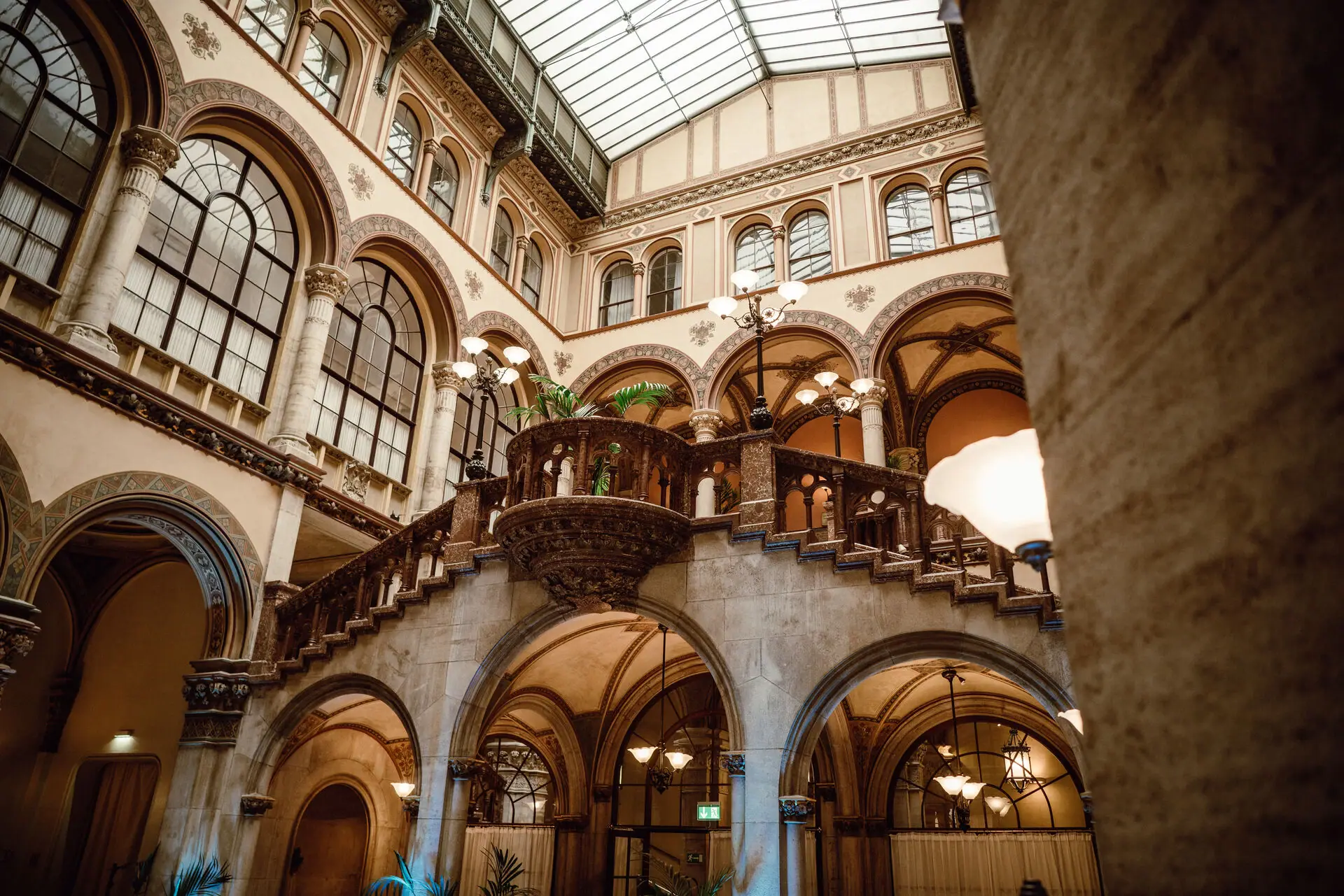 A large building with a staircase and a glass roof.