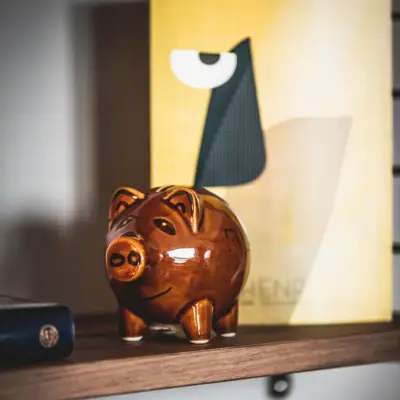 Ceramic money box on a shelf