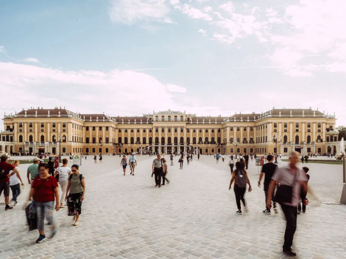 A group of people are walking in a courtyard.